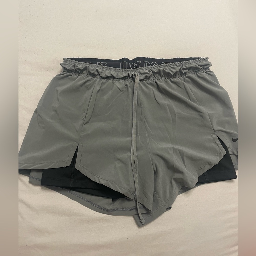 Gray Nike running shorts with attached black spandex underneath